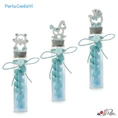 three glass bottles filled with blue candy sticks