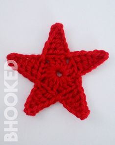 a red crocheted star ornament on a white background