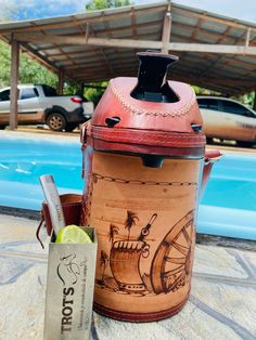 a cooler sitting next to a pool with a lime in it