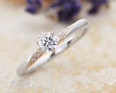 a diamond ring sitting on top of a table