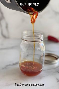 a person pouring honey into a jar with the words, how to make homemade hot honey