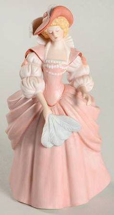 a figurine of a woman in a pink dress