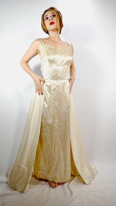 Mike Benet Formals Ivory Evening Gown Old Hollywood Glamour Circa 1960s ✨Great condition, but there are a few spots found that are worth noting. A red dot by the right hip. Very faint. And a dark colored line towards the back bottom. ✨Gold Floral Brocade ✨Metal Zipper Down Back Bust: 36" Waist: 28.5" Hips: 52" Shoulders: 15.5" Length: 52" I do not accept returns or trades. Please read the description carefully. I am always happy to answer questions prior to your purchase. #nbvavailable 1960s Dresses Formal, 1960s Dresses, Old Hollywood Glamour, Fashion Board, Dresses Formal, Gold Floral, Red Dots, Hollywood Glamour, Metal Zipper