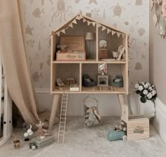 a doll house is sitting on top of a book shelf in the corner of a child's room