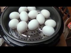 a bunch of white eggs sitting in a pot on top of a stove burner