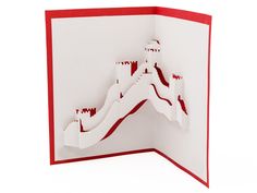 a white and red card with a castle in the middle that is cut out from paper