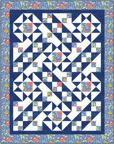 a blue and white quilt with an abstract design on the front, featuring triangles in different colors