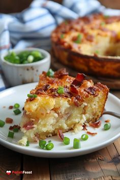 a slice of quiche on a white plate with green onions and peas next to it