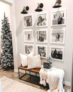 a living room decorated for christmas with pictures on the wall and photos hanging above it