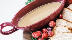 a plate topped with meat and fruit next to a bowl of soup