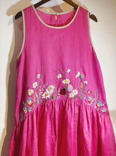 ❤ Item description: - A lovely dress with colourful embroidered mushroom, ladybug, grass and flower motifs. - Material: linen, button, embroidery threads. - Environmentally friendly. - This dress is very useful, go with any outfit, that can be used to go to school, go out, go shopping.    It is a perfect gift for yourself or your beloved.  ❤ Care instructions:     The best way to wash embroidery cloth is to put it in soapy water (with a mild detergent and cold water at 86 ºF/30oС) for 20 minutes. Try to not wash the item with other clothing that might cause damage, such as zippers, buttons or different colors. You wash it by hand, and if you have dirty patches on your garment, you can gently rub them, it's best not to rub directly against the embroidery. Rinse with clean water. Then, hangi Hand Embroidered Dress, Button Embroidery, Pink Linen Dress, Frocks Design, Kids Frocks Design, Flower Motifs, Kurti Design, Embroidery Threads, Lady Dress