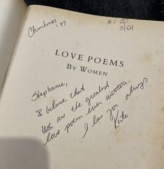 an open book with writing on it that says love poem written in cursive ink