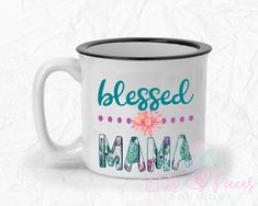 a white coffee mug with the words, blessed mama on it and a pink flower