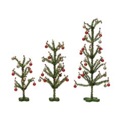 three small christmas trees with ornaments on them