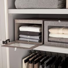 an organized closet with folded towels and folded linens in bins on the shelves