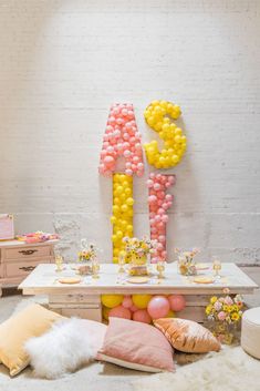 a table with balloons and decorations on it