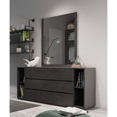 a large mirror sitting on top of a wooden dresser next to a book shelf and ottoman