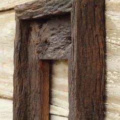 a close up of a piece of wood with a wooden frame on it's side