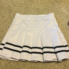 This Skirt From Spirit Halloween (Size M) Is The Perfect Skirt For A Cheerleader Costume. It Was Worn Once, And Never Worn Again So It’s Practically Brand New! Its Elastic Waistband Makes It Snug But Doesn’t Make It Hard To Breathe. The Pleats Flow Nicely When Walking Or Spinning, And They Are Not See-Through. It’s Perfect For An Everyday Outfit Or Halloween! Black Cheerleaders, Cheerleader Costume, Skirts White, Everyday Outfit, Spirit Halloween, White Skirts, Cheerleading, Everyday Outfits, Spinning