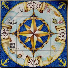 a ceramic tile with an image of a compass