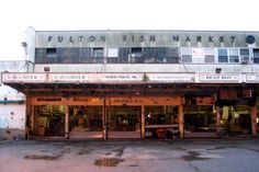 an old building with lots of cars parked in front