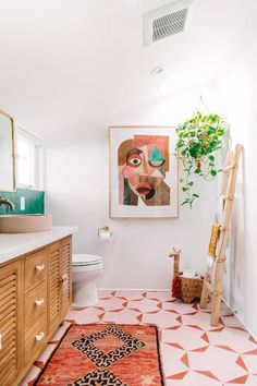 a bathroom with white walls and an orange rug in front of the sink, toilet and mirror