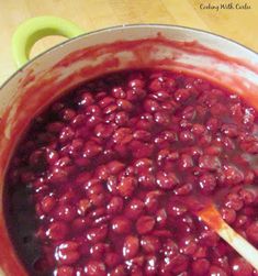 a pot filled with red beans on top of a wooden table