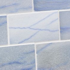 a white and blue tile wall that is very close to the ground