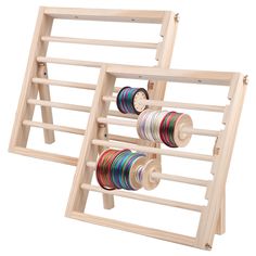 two wooden racks holding different colored spools of thread