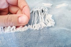 someone is peeling the fabric off of a pair of jeans with their thumbnails