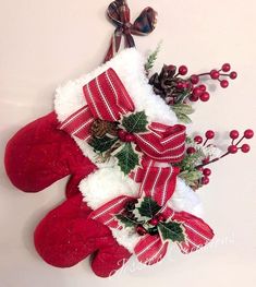 christmas stockings with holly and pine cones on them