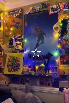 a room with posters, lights and stuffed animals on the wall in front of it