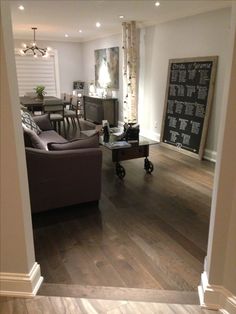 a living room filled with furniture and a wooden floor