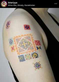 a woman's arm with colorful tattoos on it