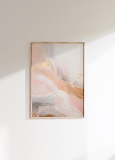 an abstract painting hangs on the wall above a chair in a room with white walls