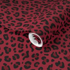 a pink and black animal print wallpaper with a white circle on the center corner