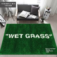 a green rug with the words wet grass written on it in white across the top