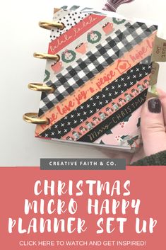 a hand holding a planner with the words christmas mickey happy planner set up