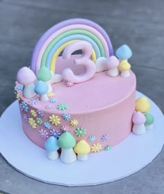 a birthday cake decorated with flowers, rainbows and the number eight on it's side