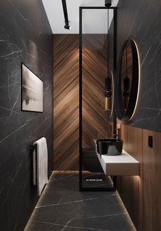 a modern bathroom with black marble and wood accents