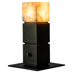 a light that is sitting on top of a black stand with two cubes attached to it