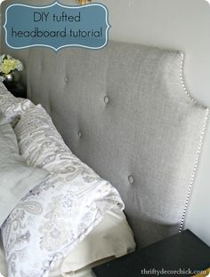 an upholstered headboard with white pillows