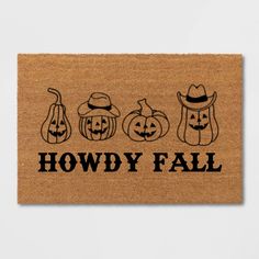 a door mat with three pumpkins and two jack - o'- lanterns