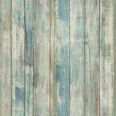 an old wooden wall with peeling paint on the wood planks, as if it were painted in blue and white