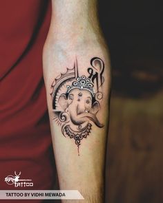 an elephant with a crown tattoo on his arm