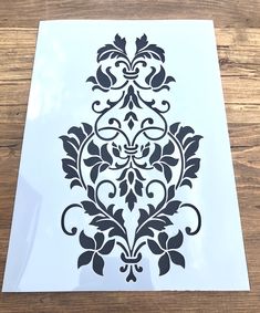 the stencil is designed to look like an ornate design on a piece of paper