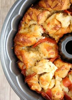 there is a bundt cake with toppings in the pan on the table, ready to be eaten