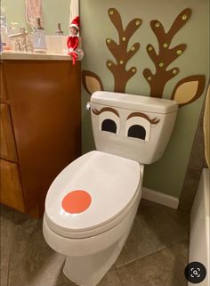 a bathroom with a toilet decorated like a reindeer