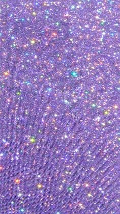 the back side of a purple cloth with small glitters on it and a white background