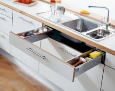 an open drawer in the middle of a kitchen counter